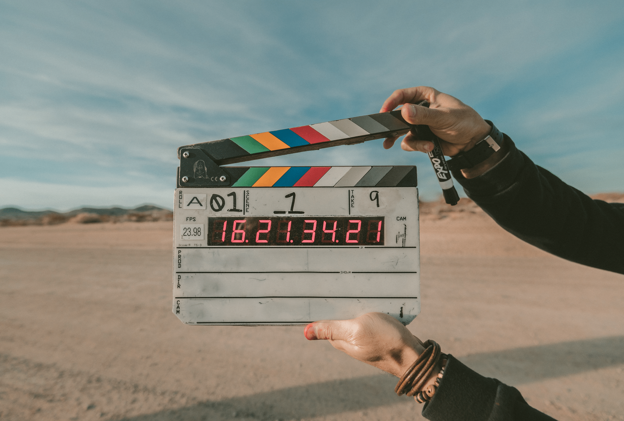 hands holding a clapperboard